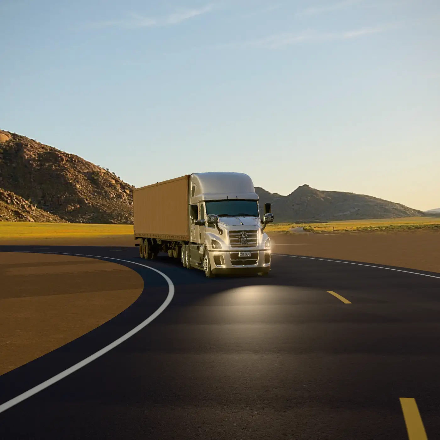 A sleeper tractor pulling a 53-foot trailer through a bend on a desert highway at golden hour